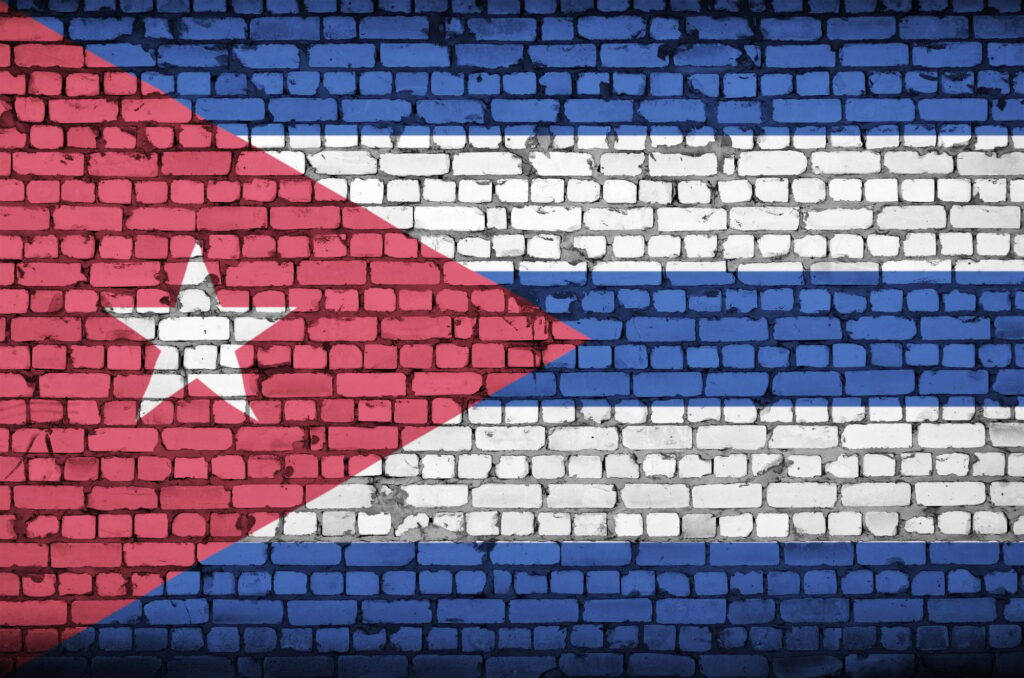 Cuba flag is painted onto an old brick wall